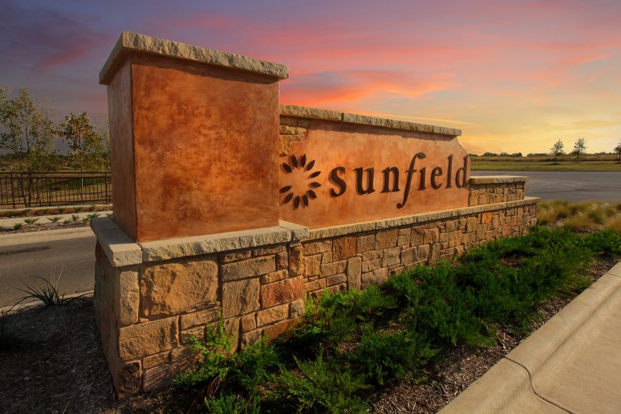 Entrance to the Sunfield community in Mustang Ridge, TX, featuring signage and landscaping (Image 1).