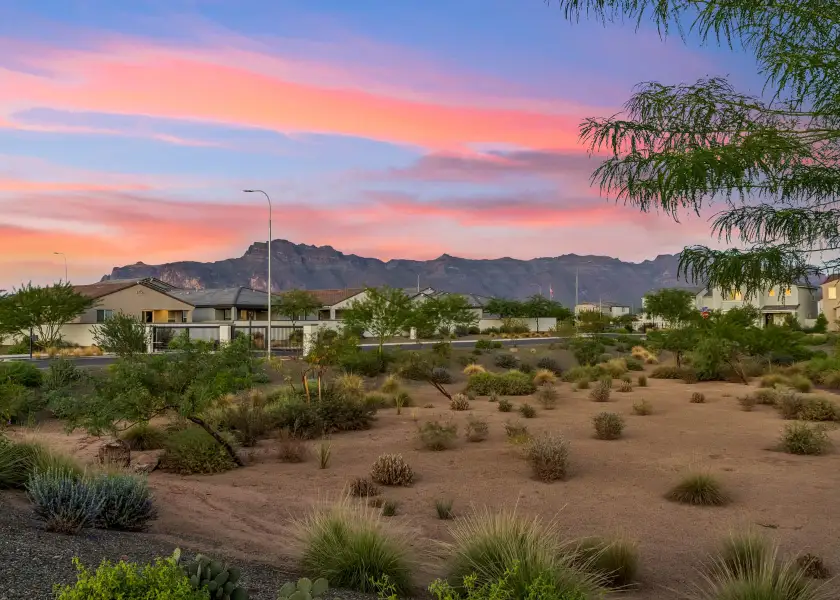A desert landscape with a building and mountains in the background. A desert landscape with a building and mountains in the background.