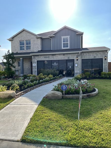 A modern two-story home with a landscaped entrance in River Ranch Meadows by Davidson Homes LLC (Dayton, TX).