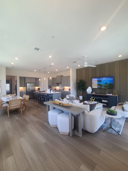 An open-concept living area with modern kitchen, cozy seating, and elegant decor. Perfect for entertaining and relaxation.