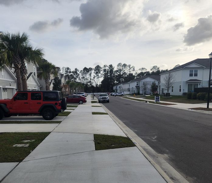 A charming suburban street with modern homes and palm trees in Wyndbrook by D.R. Horton (Jacksonville, FL). A charming suburban street with modern homes and palm trees in Wyndbrook by D.R. Horton (Jacksonville, FL).