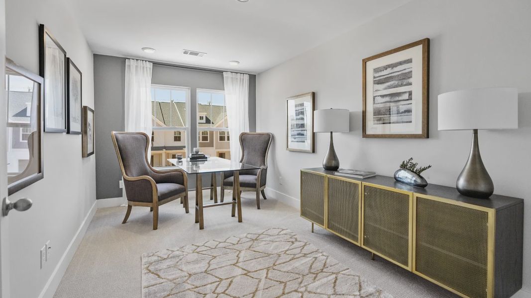 Carpeted secondary bedroom with two large windows in two story townhome at Ransdell Pointe by DRB Homes in Spartanburg, SC