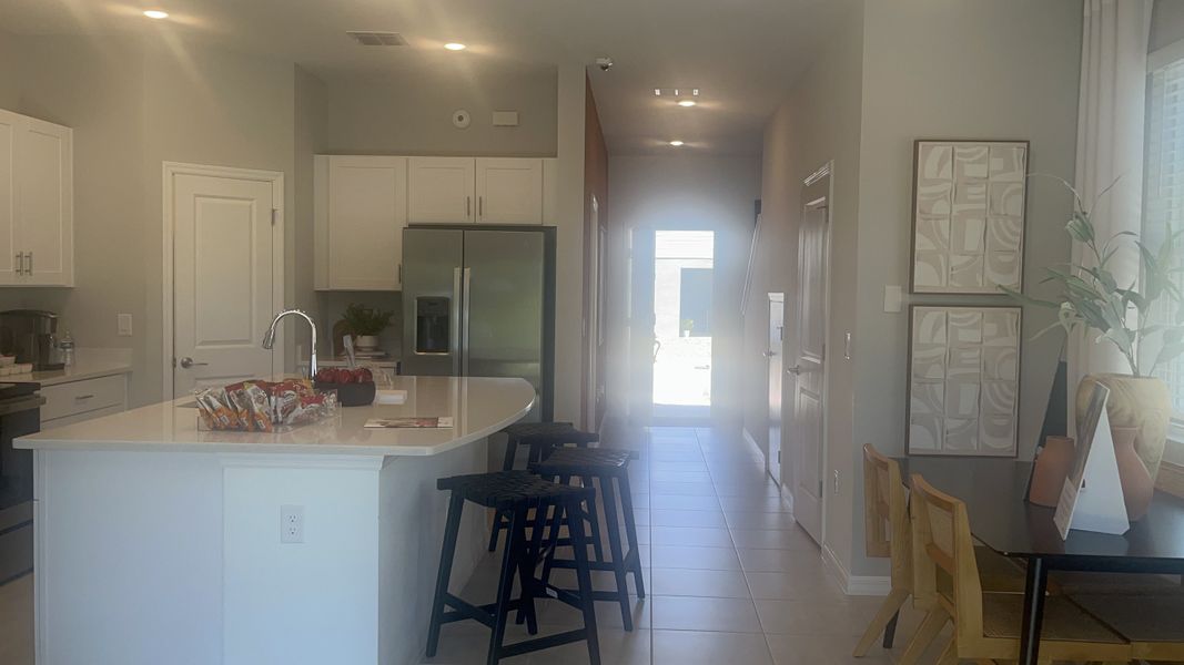 A bright kitchen with an island, modern appliances, and chic décor. Perfect for family gatherings and entertaining.