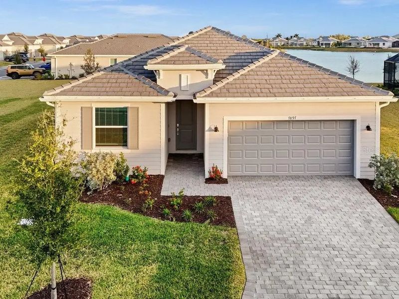 Front exterior of a home in the Harbor East: Executive Homes community, located in Port Charlotte, FL (Image 2).