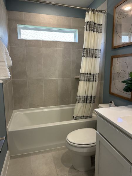 A modern bathroom with a sleek shower, elegant vanity, and chic decor accents. A modern bathroom with a sleek shower, elegant vanity, and chic decor accents.