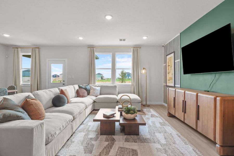 A living room with a tv and couches. A living room with a tv and couches.