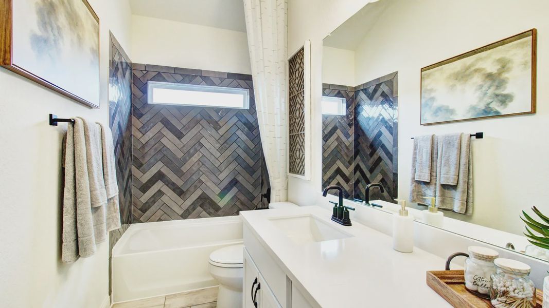 Experience luxury with herringbone tiles and sleek fixtures, creating a refined oasis in Veranda community.