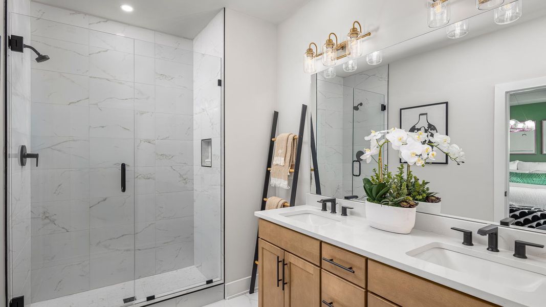 Lavish primary bath with a dual sink vanity and large shower