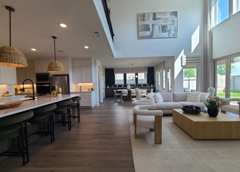 A modern open-plan living area with sleek kitchen, stylish dining, and cozy lounge, all bathed in natural light.