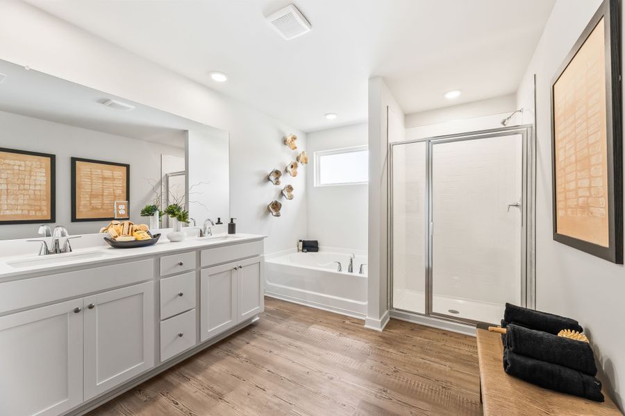 A bathroom with a tub and sink. A bathroom with a tub and sink.