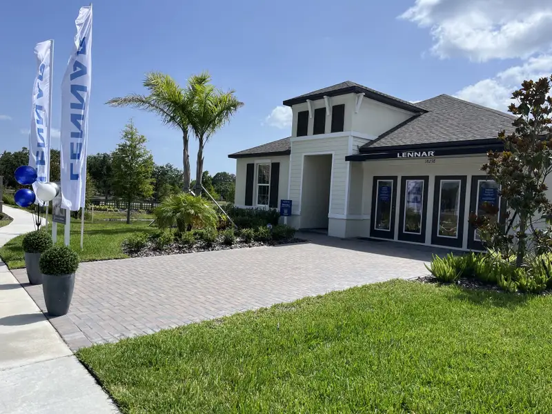 A charming modern home with manicured landscaping in Pearl Estates by Lennar (Lutz, FL).
