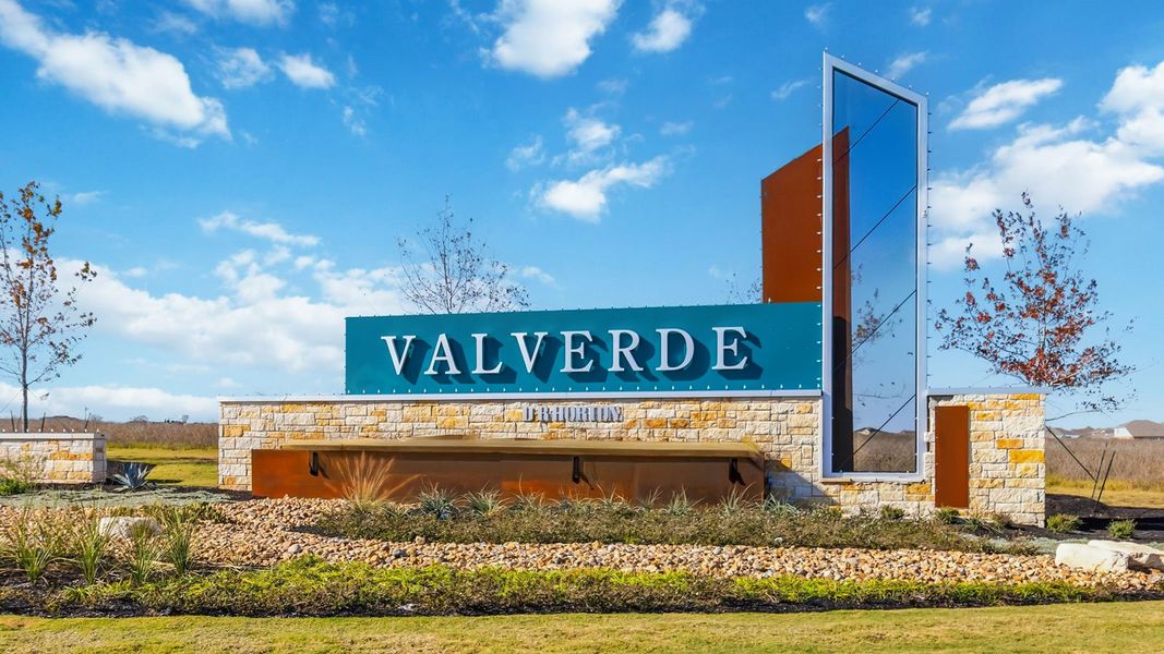Entrance to the Valverde community in Bastrop, TX, featuring signage and landscaping (Image 1). Entrance to the Valverde community in Bastrop, TX, featuring signage and landscaping (Image 1).