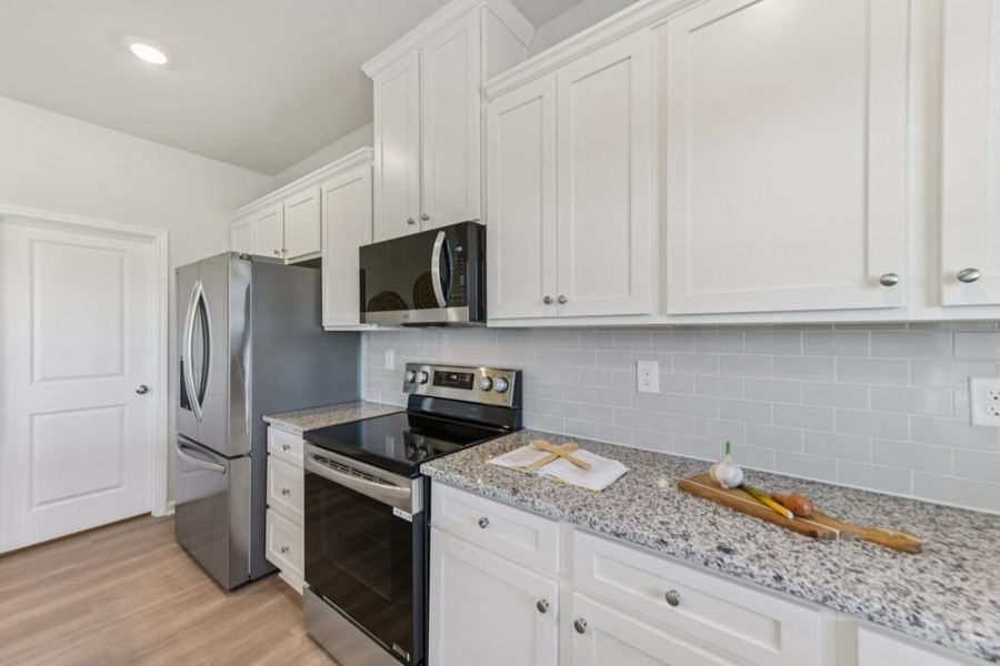 Furnished interior in a model home at The Hills at Cedar Creek in Winder (Image 48).