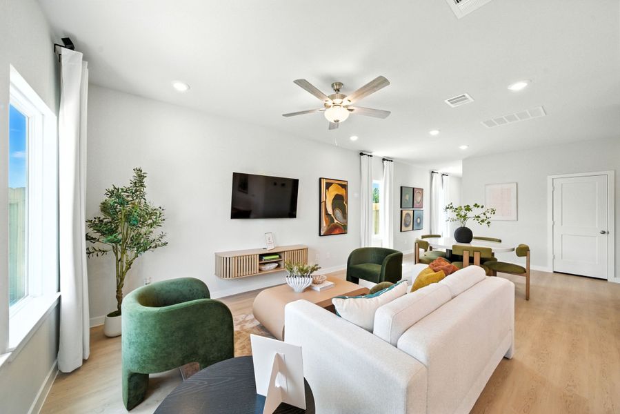 A living room with a tv and couches. A living room with a tv and couches.