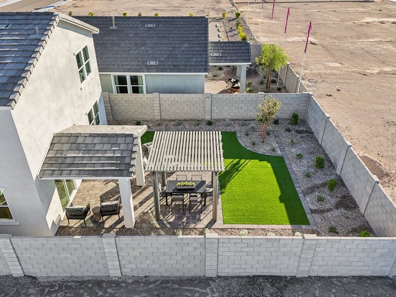 A backyard with a table and chairs.