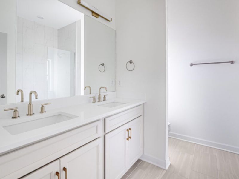 The primary suite offers dual vanity sinks and a walk-in shower.