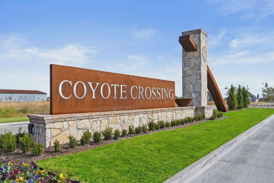 Entrance to the Coyote Crossing community in Godley, TX, featuring signage and landscaping (Image 3). Entrance to the Coyote Crossing community in Godley, TX, featuring signage and landscaping (Image 3).