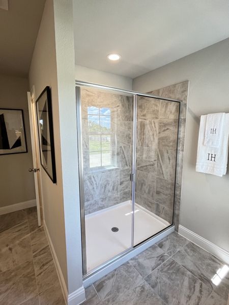 A sleek bathroom featuring a glass-enclosed shower with elegant gray tiles and a modern, streamlined design. A sleek bathroom featuring a glass-enclosed shower with elegant gray tiles and a modern, streamlined design.