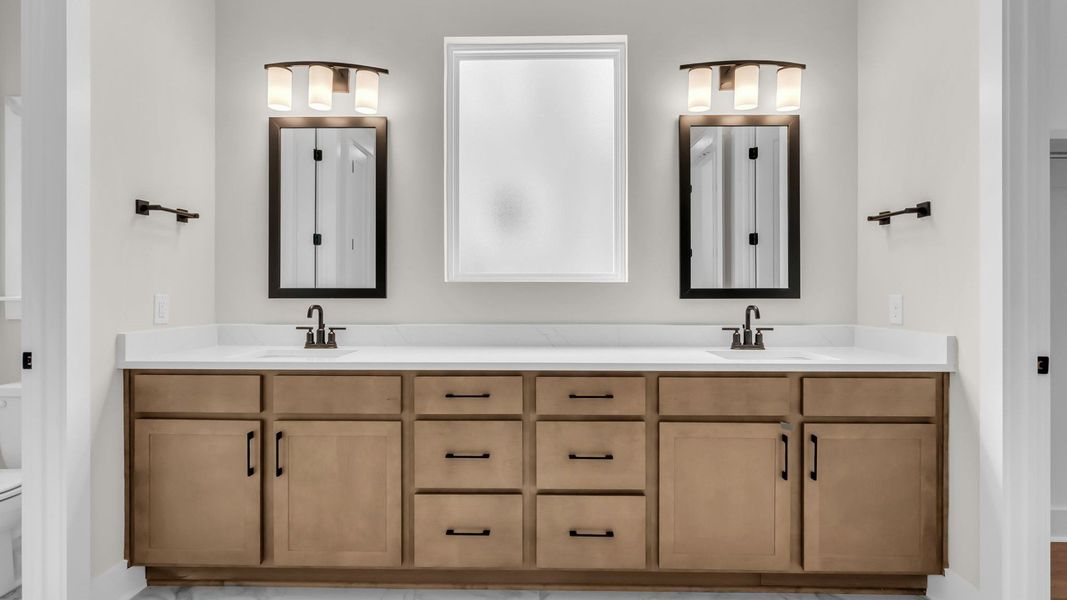 Primary suite bathroom with dual-vanity and natural light Primary suite bathroom with dual-vanity and natural light