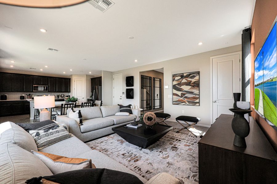 A living room with a large television. A living room with a large television.