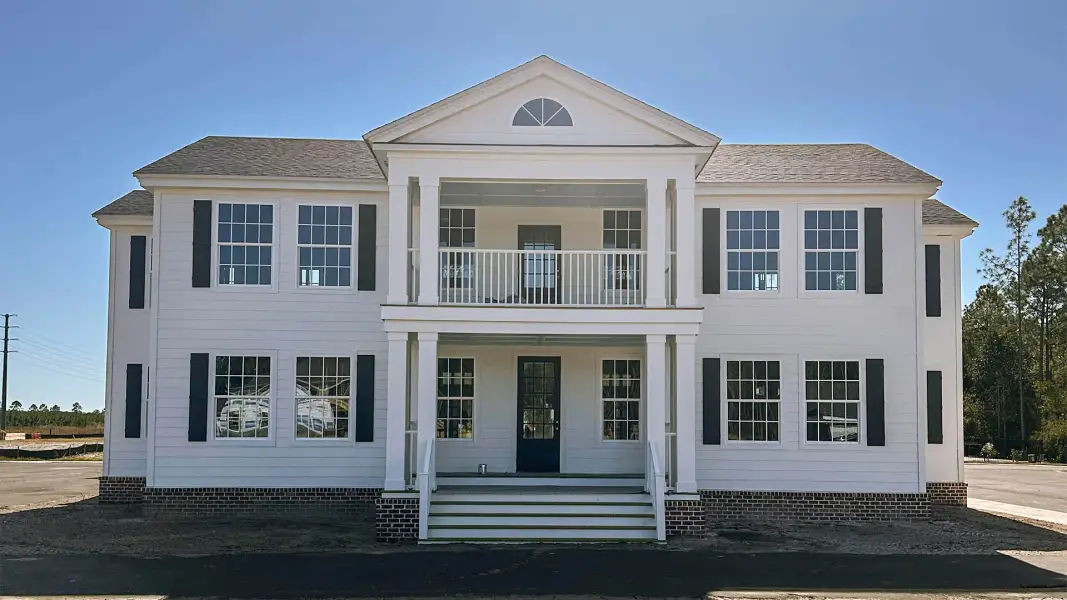 Front exterior of a home in the Chateau Nemours Townhomes community, located in Port Saint Joe, FL (Image 5).