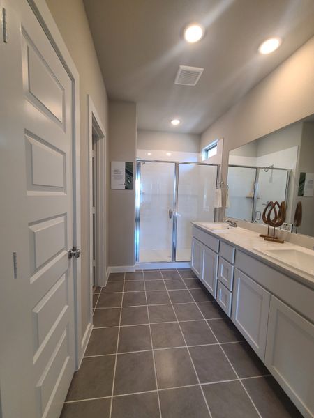 A modern bathroom featuring dual sinks, sleek cabinetry, and a spacious glass shower for a luxurious feel. A modern bathroom featuring dual sinks, sleek cabinetry, and a spacious glass shower for a luxurious feel.