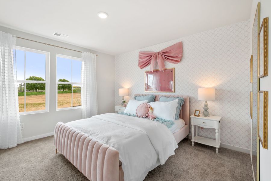 A bedroom with a bed and lamps.