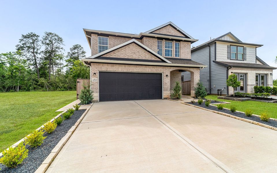 Front exterior of a home in the The Pines at Seven Coves community, located in Willis, TX (Image 8).
