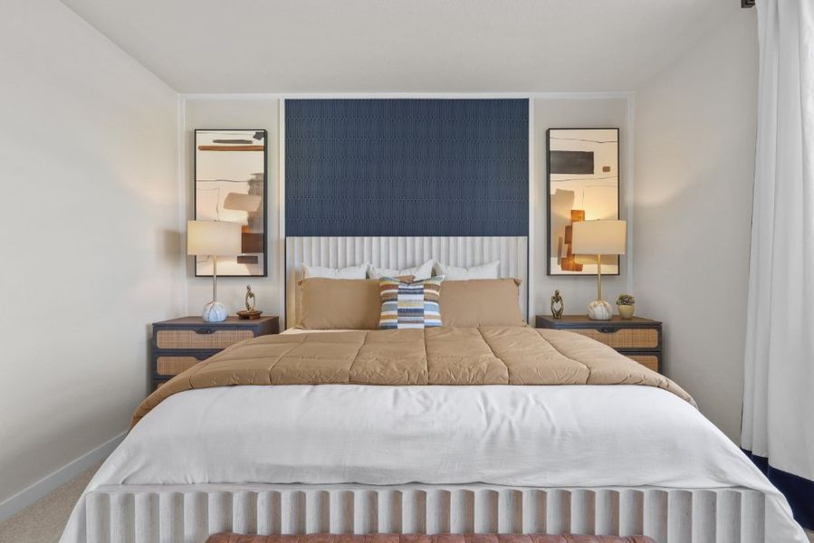 A bed with a mirror on the wall.