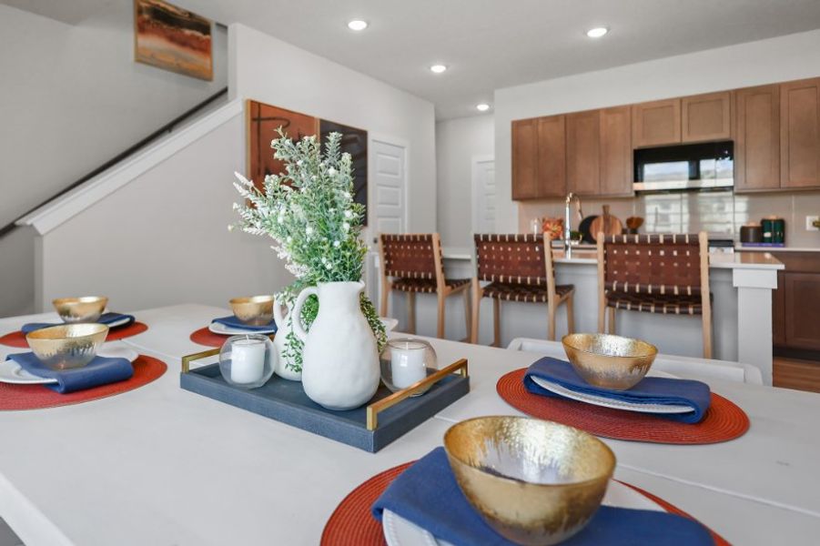 A kitchen with a table set with plates and bowls.