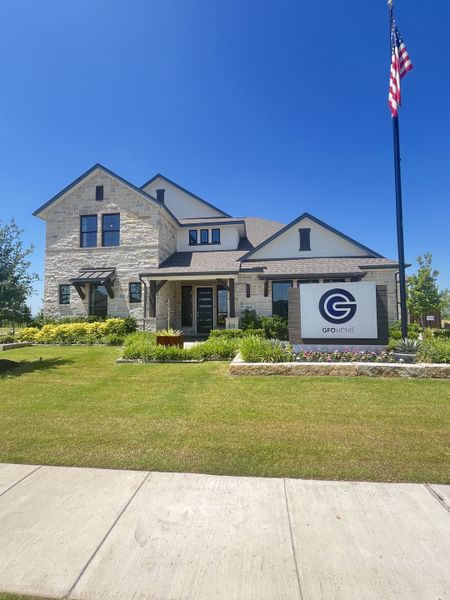 A stunning stone home with manicured landscaping in Polo Ridge by GFO Home, Forney, TX. A stunning stone home with manicured landscaping in Polo Ridge by GFO Home, Forney, TX.