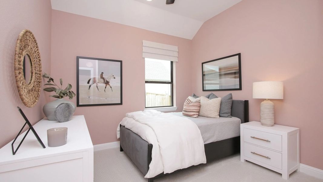 Luxurious bedroom featuring soft pink walls and tasteful decor, set in the esteemed Coastal Point community.