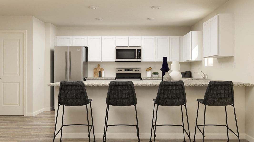 A kitchen with white cabinets.