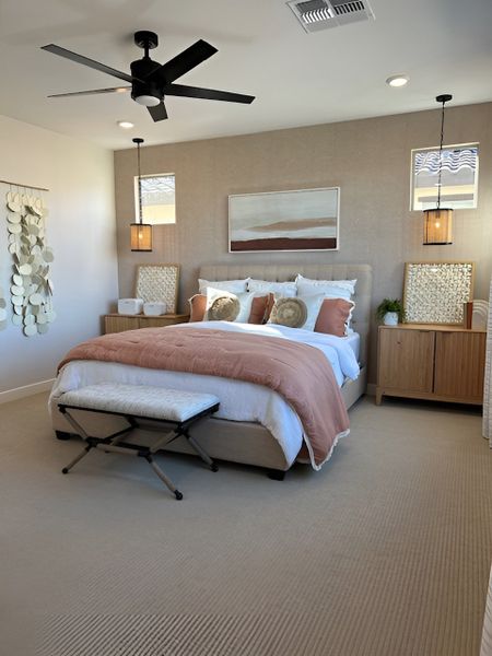 A cozy bedroom with a neutral color palette, warm-toned decor, and pendant lighting for a serene ambiance.