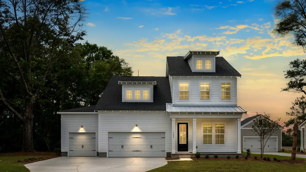 Lighthouse exterior at twilight with 3-car garage