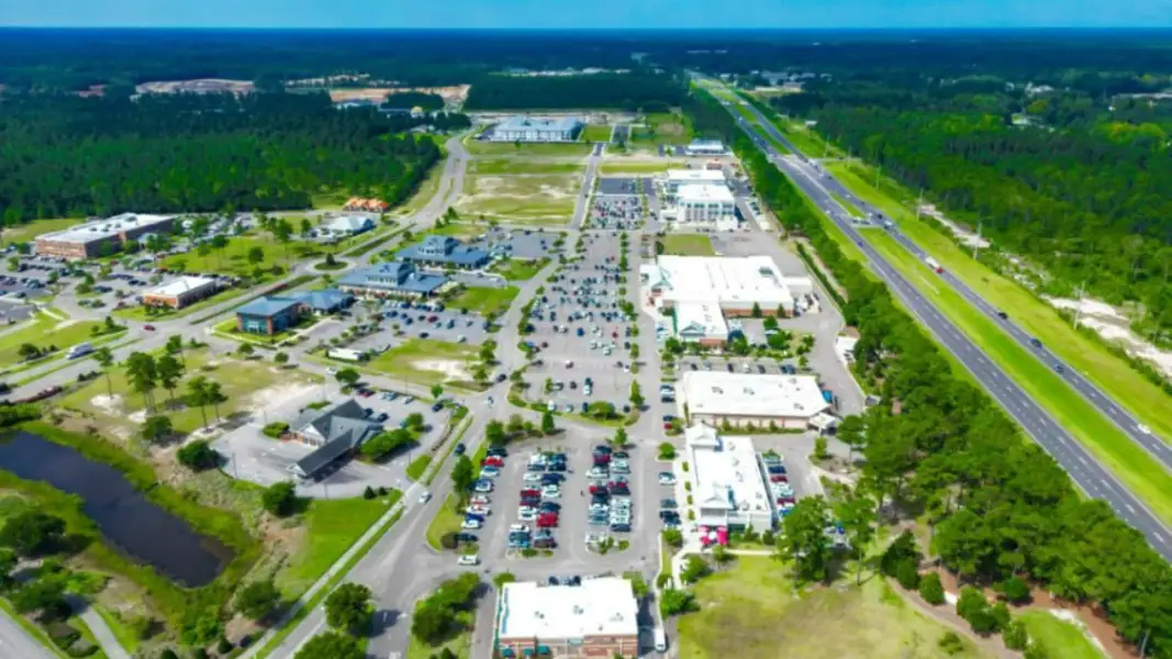Aerial view of the The Townes at Cedar Hill Landing community in Navassa, NC, showing layout and nearby surroundings (Image 12).