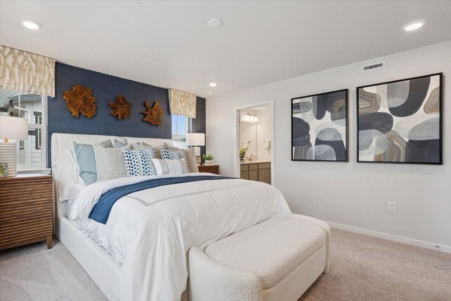 A bedroom with a bed and a couch.