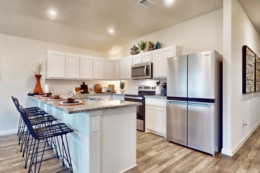A kitchen with white cabinets. A kitchen with white cabinets.