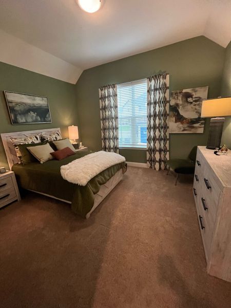 A cozy bedroom with green walls, elegant art, and soft lighting creating a serene ambiance. A cozy bedroom with green walls, elegant art, and soft lighting creating a serene ambiance.