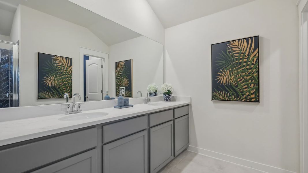 Sophisticated dual-sink vanity with elegant marble finish and custom cabinetry in Churchill community. Sophisticated dual-sink vanity with elegant marble finish and custom cabinetry in Churchill community.