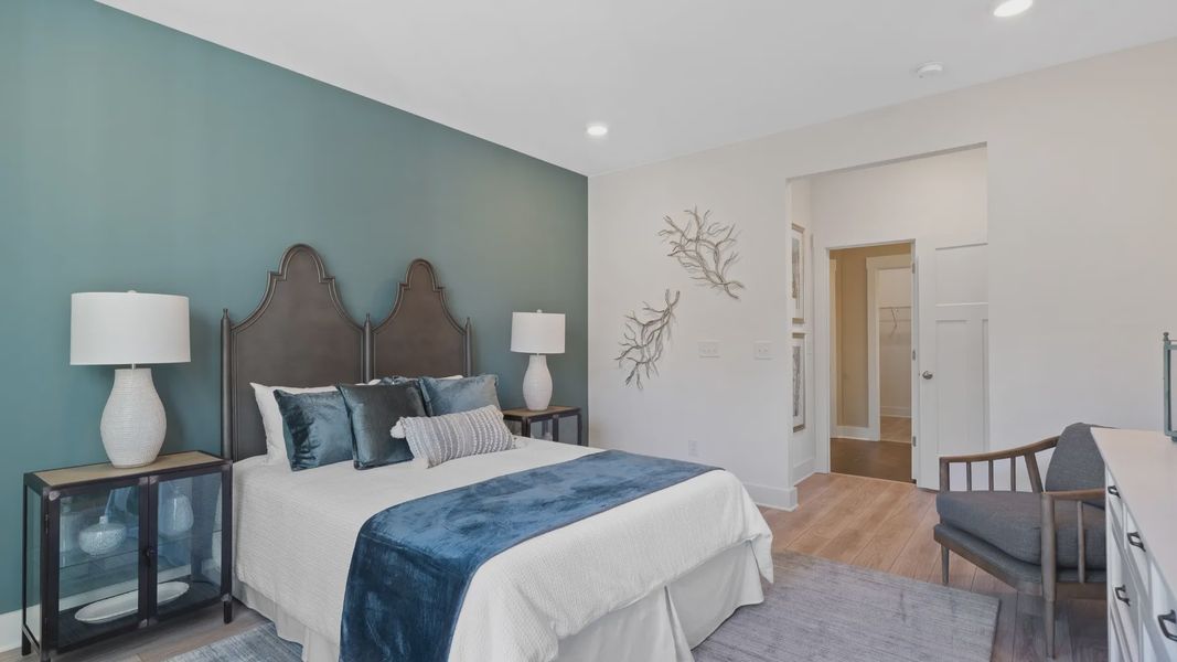 Lakehurst primary suite at Village at Midway with farmhouse decor, dark accent wall, en suite bathroom and LVP by DRB Homes Lakehurst primary suite at Village at Midway with farmhouse decor, dark accent wall, en suite bathroom and LVP by DRB Homes