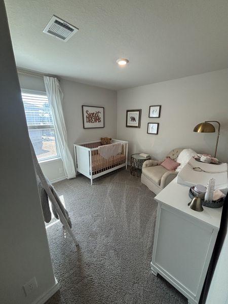 Charming nursery with a cozy crib, plush chair, and soft lighting, perfect for sweet dreams.