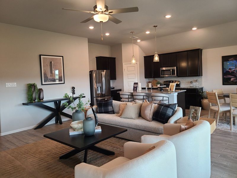 An inviting open-concept living area with modern decor, a sleek kitchen, and cozy seating arrangements. An inviting open-concept living area with modern decor, a sleek kitchen, and cozy seating arrangements.