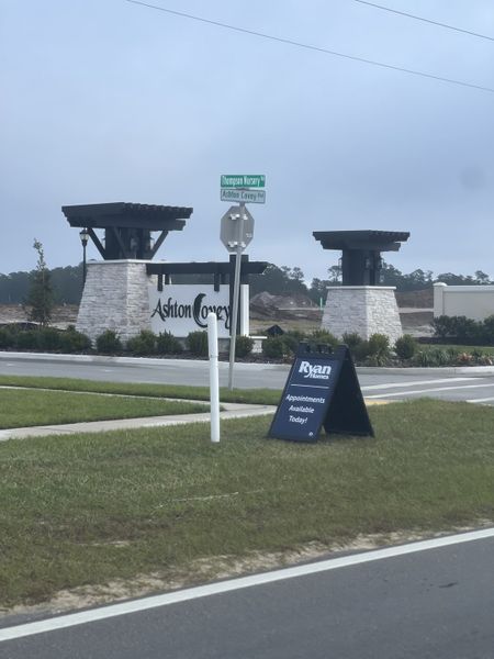 Welcome to Ashton Covey by Ryan Homes in Winter Haven, FL—an inviting community with stylish entrance signage.