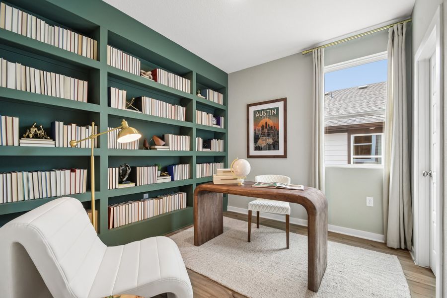 A room with a table and bookshelves.
