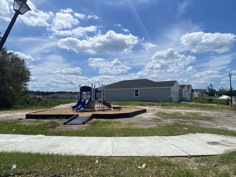 A community playground with blue slides in Cypress Meadows - Signature Series by Meritage Homes in Jacksonville, FL.