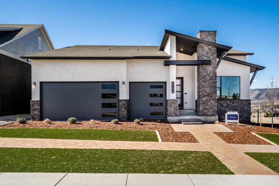 Front exterior of a home in the Cloverleaf - Pinnacle Collection community, located in Monument, CO (Image 1).