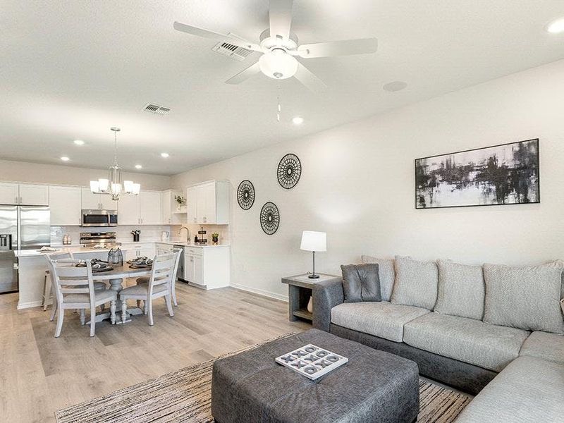 These 2-story townhomes feature a sunny, open-concept living area - Flora townhome by Highland Homes