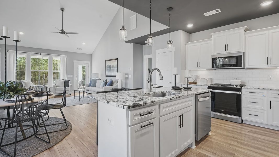 Kitchen with whirlpool appliances, modern accents, crown molding and granite countertops in Anderson, SC by DRB Homes Kitchen with whirlpool appliances, modern accents, crown molding and granite countertops in Anderson, SC by DRB Homes