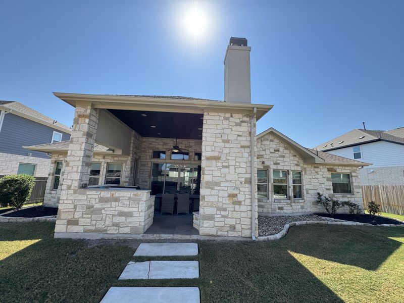 Charming stone home with a covered patio in Blackhawk by Scott Felder Homes, Pflugerville, TX.